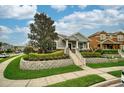 Charming single-story home with manicured lawn and stone accents, showcasing curb appeal and inviting entrance at 707 Brandy Oaks Loop, Winter Garden, FL 34787