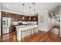 Gourmet kitchen featuring a large island, stainless steel appliances, and rich wood cabinetry at 707 Brandy Oaks Loop, Winter Garden, FL 34787