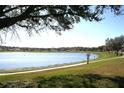 Scenic view of a tranquil lake within the neighborhood, perfect for peaceful walks and relaxation at 7756 Beridale Ct, Orlando, FL 32818