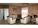 Inviting living room with textured walls, elegant furniture, and a cozy atmosphere, ideal for relaxation at 7756 Beridale Ct, Orlando, FL 32818