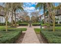 Beautiful community featuring manicured greenery, brick walkways, and a central water feature at 8742 European Fan Palm Aly, Winter Garden, FL 34787