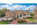 Beautiful lakefront property featuring a tile roof, manicured lawn, and a grand entrance at 9243 Point Cypress Dr, Orlando, FL 32836