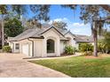 Beautiful home exterior featuring a well-manicured lawn, three car garage, and tile roof at 9308 Thurloe Pl, Orlando, FL 32827