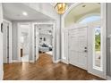 Welcoming foyer with hardwood floors, featuring a view into the bathroom and bedroom at 9308 Thurloe Pl, Orlando, FL 32827