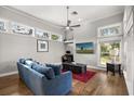 Bright living room with large windows, a ceiling fan, and a view of the outdoors at 9308 Thurloe Pl, Orlando, FL 32827