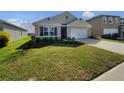 Inviting single-Gathering home with a lush green lawn, tidy landscaping and a neutral color palette at 944 Brooklet Dr, Davenport, FL 33837