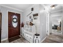 Inviting entryway with wood-look tile flooring, decorative accents, and stylish front door at 9729 Heatherwood Ct, Orlando, FL 32825