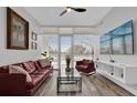 Bright living room with a view, sleek furnishings and a mounted television at 101 S Eola Dr # 509, Orlando, FL 32801
