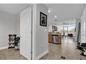 Open-concept living space with tile floors and view to dining area with large windows at 101 S Eola Dr # 509, Orlando, FL 32801