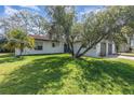 Inviting home exterior with lush green lawn and mature trees at 10339 Manila Bay Dr, Orlando, FL 32821