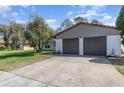 View of the two-car garage with gray doors and neutral-colored exterior at 10339 Manila Bay Dr, Orlando, FL 32821