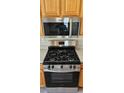 Close-up of a modern stainless steel stove and microwave with a sleek design in a well-equipped kitchen at 12151 Goldenstar Ln, Clermont, FL 34711
