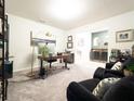 Bright home office with stylish desk, black arm chairs, and modern decor at 1217 Michelangelo Ln, Winter Haven, FL 33884
