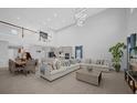 Open-concept living space with soaring ceilings and seamless flow to the kitchen at 1240 Lone Palm Way, St Cloud, FL 34771