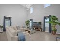 Bright living room with high ceilings, neutral colors, and abundant natural light at 1240 Lone Palm Way, St Cloud, FL 34771