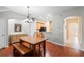 Spacious dining room with a wooden dining set and hardwood floors that flow into the adjacent kitchen at 1270 Falling Star Ln, Orlando, FL 32828