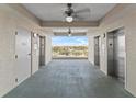 Elevator bay showcasing two elevators, decorative lighting, and view of the city at 13415 Blue Heron Beach Dr # 610, Orlando, FL 32821