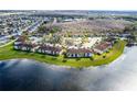 Aerial view of a condo community surrounded by water and lush greenery at 13801 Timberland Dr # 202, Orlando, FL 32824