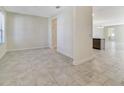 Bright, open-concept living area with neutral paint, tile flooring, and natural light from the window at 15088 Night Heron Dr, Winter Garden, FL 34787