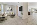 Inviting living room with tile floors, recessed lighting, and an open floor plan at 15088 Night Heron Dr, Winter Garden, FL 34787