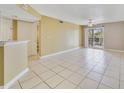 Bright living room with tile floors, a ceiling fan, and a sliding glass door to the outside at 1948 Lake Atriums Cir # 129, Orlando, FL 32839