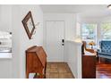 Welcoming entryway featuring tile flooring, a decorative mirror, and a charming vintage desk at 2413 Tack Room Ln # 2, Orlando, FL 32812