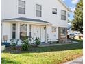Charming two-story exterior with a well-maintained lawn, an inviting front door, and a bay window at 2413 Tack Room Ln # 2, Orlando, FL 32812