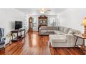 Bright living room with hardwood floors, a ceiling fan, and a comfortable sectional sofa at 2413 Tack Room Ln # 2, Orlando, FL 32812