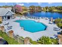 Community pool and sundeck overlooking a picturesque lake at 2413 Tack Room Ln # 2, Orlando, FL 32812