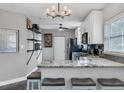 Modern kitchen featuring white cabinets, granite countertops, stainless steel appliances, and stylish lighting at 2812 Mulford Ave, Winter Park, FL 32789
