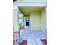 Covered home entrance with a brick paved walkway and landscaping at 3219 Cup Dr, Lakeland, FL 33803