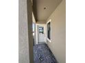 A well-lit covered entryway with a stylish white front door and side window at 3219 Cup Dr, Lakeland, FL 33803