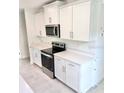 Close up of kitchen with white cabinets and stainless steel appliances at 3219 Cup Dr, Lakeland, FL 33803