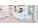Bright kitchen featuring an island with bar seating and stainless steel appliances at 3219 Cup Dr, Lakeland, FL 33803