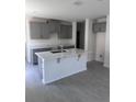 Modern kitchen with gray cabinets, quartz countertops, and an island perfect for meal prep and entertaining at 3352 Cup Dr, Lakeland, FL 33803