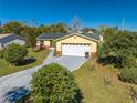 Charming yellow home with solar panels, and long driveway at 401 Cart Ct, Kissimmee, FL 34759