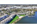 Aerial view of complex on lakefront featuring beach access, pool, and docks at 4117 Fairview Vista Pt # 206, Orlando, FL 32804