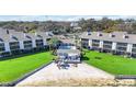 Aerial view of the lakeside condo complex with a pool, a gazebo, and beach access at 4117 Fairview Vista Pt # 206, Orlando, FL 32804