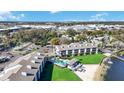 Aerial view of complex featuring a pool, beach access, and lake with docks at 4117 Fairview Vista Pt # 206, Orlando, FL 32804