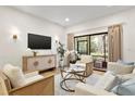 Cozy living room featuring modern decor, a large window, and stylish furniture at 535 N Interlachen Ave # 106, Winter Park, FL 32789