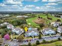 Aerial view of townhomes near a golf course and lake, perfect for a resort lifestyle at 7691 Heritage Crossing Way # C-1, Reunion, FL 34747