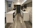 Modern kitchen area with sleek white countertops, a brick wall, and an industrial feel at 803 N Pine Hills Rd, Orlando, FL 32808