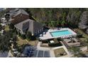 Aerial view of the community pool area featuring lounge chairs, umbrellas, and a small playground nearby at 9575 Silver Buttonwood St, Orlando, FL 32832