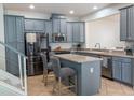 Beautiful kitchen featuring gray cabinets, stainless steel appliances, and a center island with bar stool seating at 9575 Silver Buttonwood St, Orlando, FL 32832