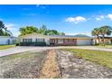 Lovely single-story home with a spacious driveway, brick accents, and beautifully manicured landscaping at 980 Oleander Se Dr, Winter Haven, FL 33880