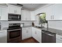 Beautiful kitchen featuring granite counters, stainless steel appliances, white cabinets and subway tile backsplash at 1021 Carlson Dr, Orlando, FL 32804