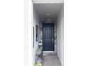 Inviting entryway featuring a black front door and decorative welcome mat at 11588 Whistling Pine Way, Orlando, FL 32832