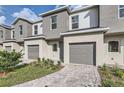 Attractive townhomes showcasing neutral exteriors, private garages, and well-kept lawns at 1209 S Station Pl # 306, Orlando, FL 32809