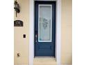 Elegant blue front door featuring decorative glass, a sleek door handle, and an electronic keypad at 136 Mcleods Way, Winter Springs, FL 32708