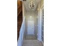 Hallway features staircase, tile flooring, neutral paint, and contemporary light fixtures at 136 Mcleods Way, Winter Springs, FL 32708